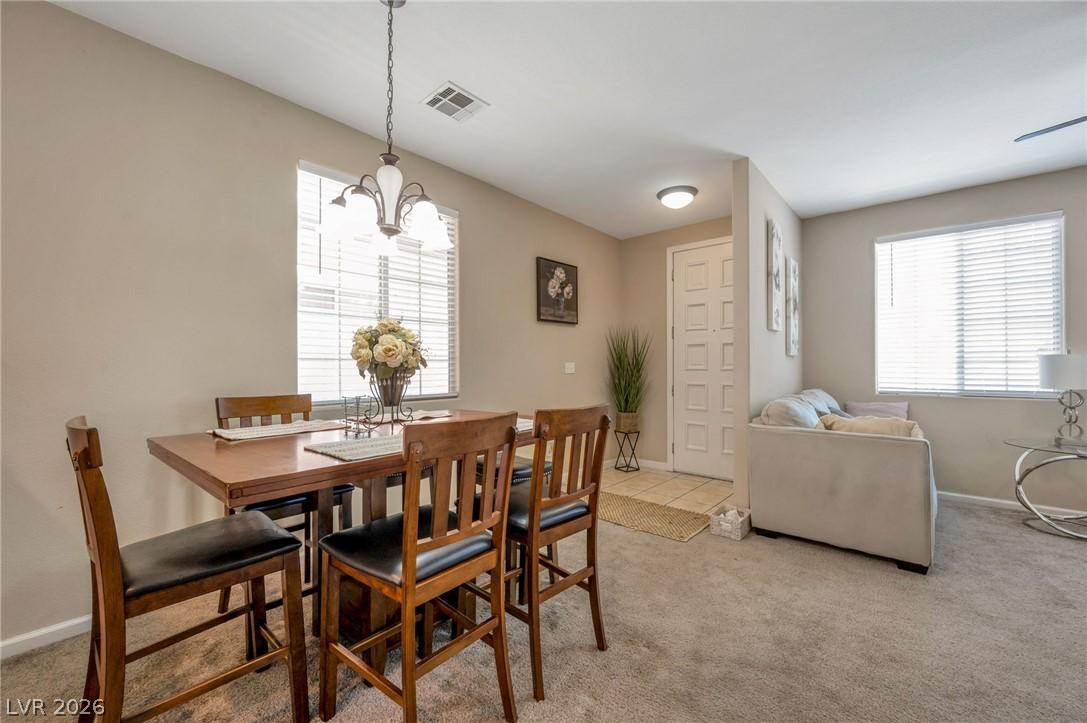 Image 3: A graceful chandelier illuminates the dining area,