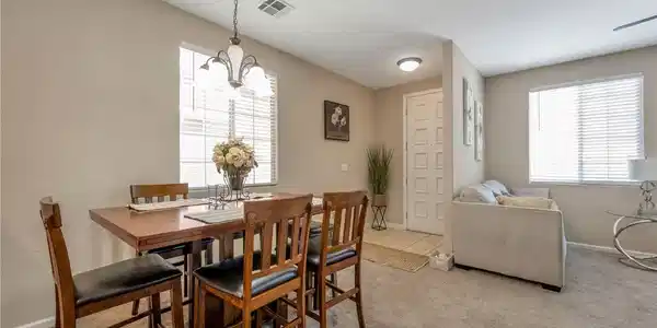 Image 3: A graceful chandelier illuminates the dining area,