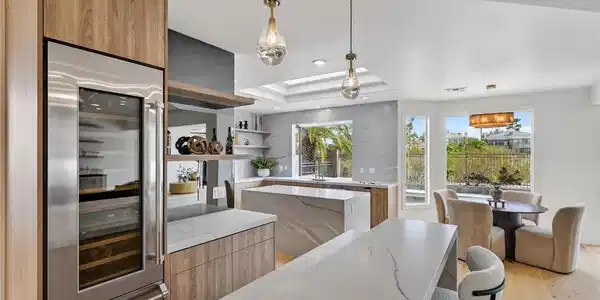 Image 2: Gleaming stone countertops and warm wood cabinetry