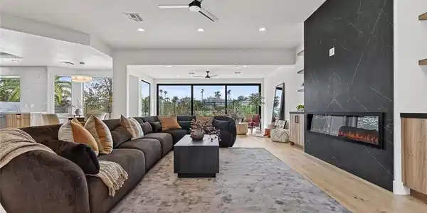 Image 3: Rich wood floors and a contemporary linear firepla