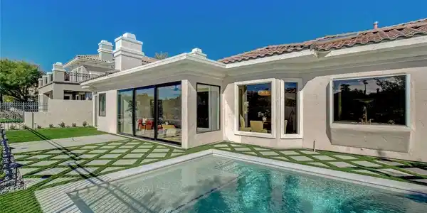 Image 4: Geometric pavers surround a sparkling backyard poo