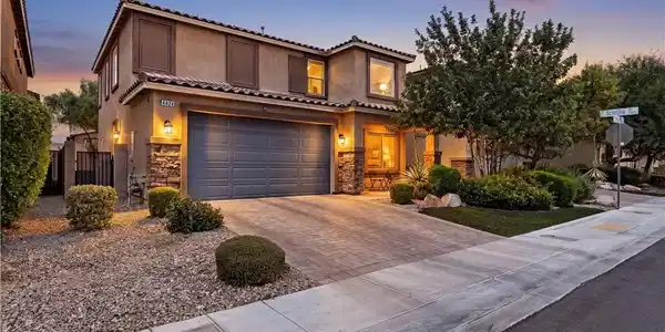 Image 2: Elegant two-story residence with a paved driveway