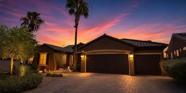 Image 2: Dramatic sunset hues illuminate the brick paver dr