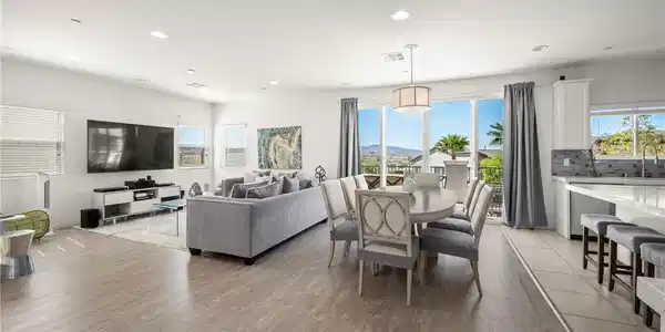 Image 3: Natural light illuminates an open-concept living s