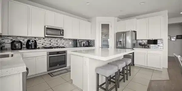 Image 4: A contemporary kitchen features bright white cabin