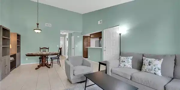 Image 3: An open layout connects the dining space and livin