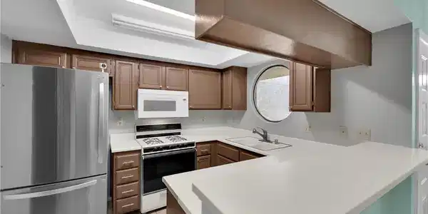 Image 4: Streamlined cabinetry and classic stone counters d