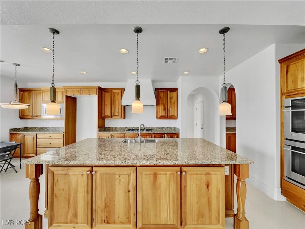 Image 4: Kitchen featuring arched walkways, pendant lightin