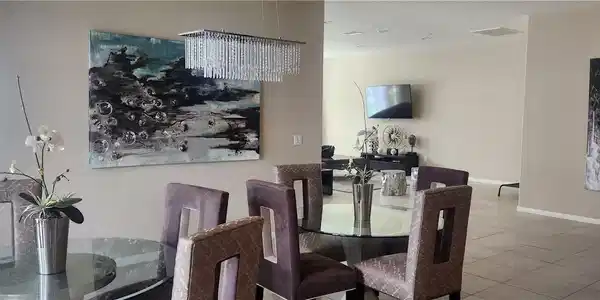 Image 3: Dining space with a chandelier and tile patterned