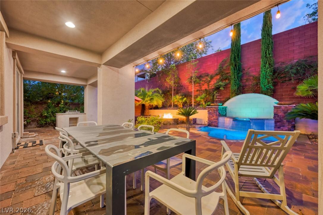 Image 2: An inviting covered patio features a dining area,