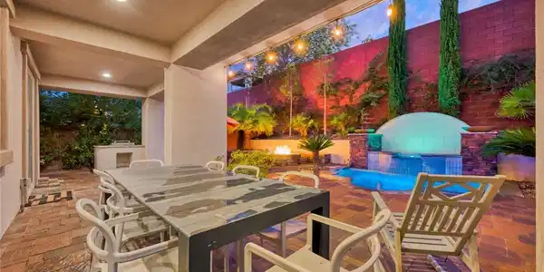 Image 2: An inviting covered patio features a dining area,