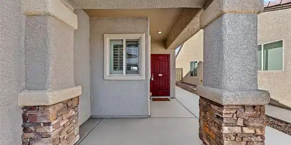 Image 2: Welcoming covered entryway features robust stone-a