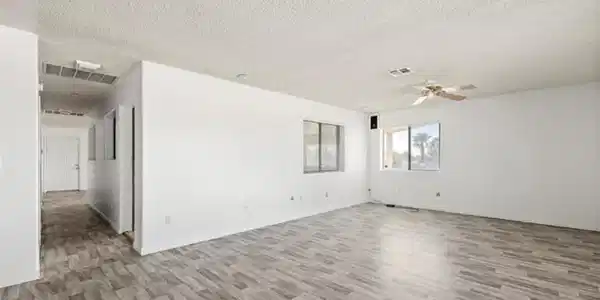 Image 4: This expansive living space features durable floor