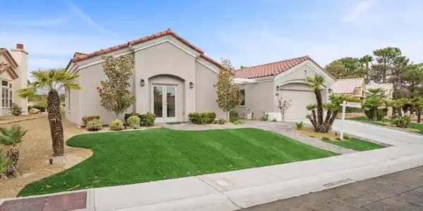 Image 2: A classic Spanish tile roof and manicured lawn hig