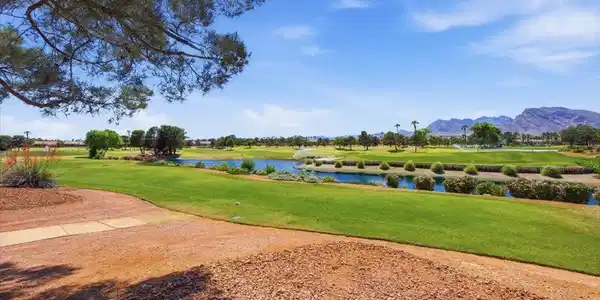 Image 3: Lush fairways and a serene water hazard frame dist
