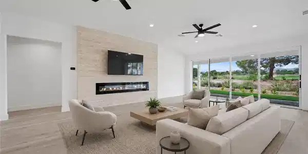 Image 4: A modern fireplace wall pairs with light wood floo