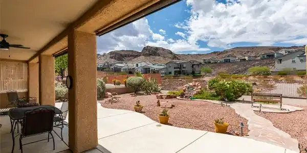 Image 2: A spacious covered patio overlooks a beautifully l