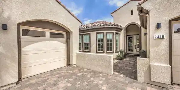 Image 3: This inviting home features a beautiful paved driv