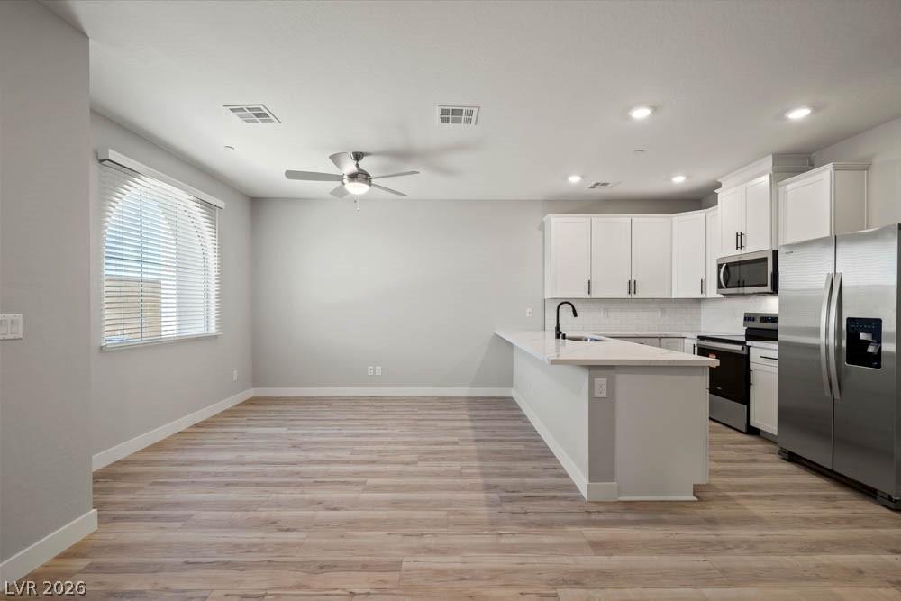 Image 2: This bright, open-concept space features a well-ap