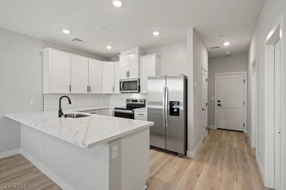 Image 3: This sleek kitchen features clean lines and modern