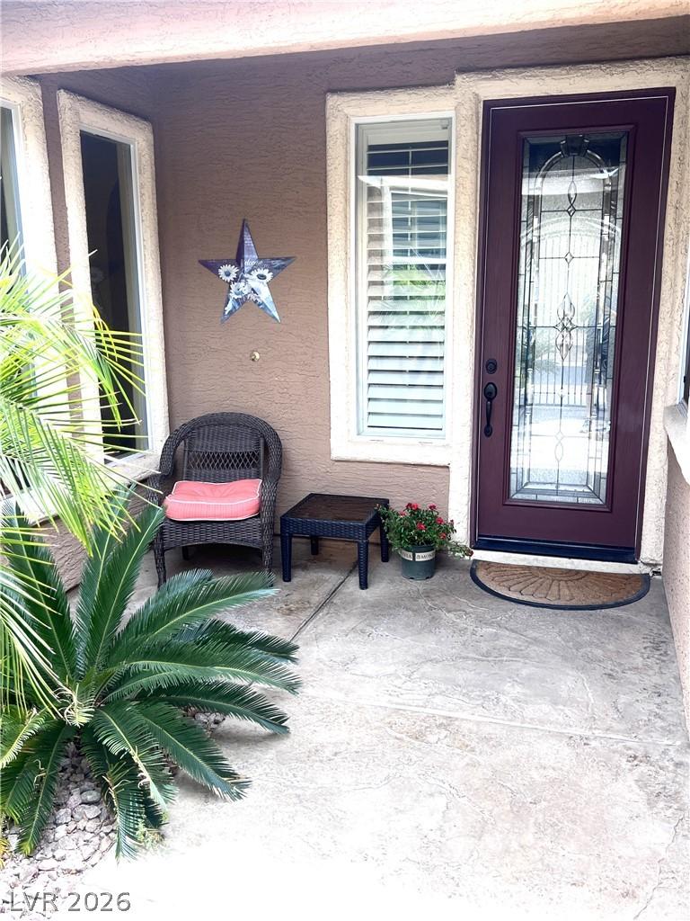 Image 3: A welcoming entry features a detailed glass door a
