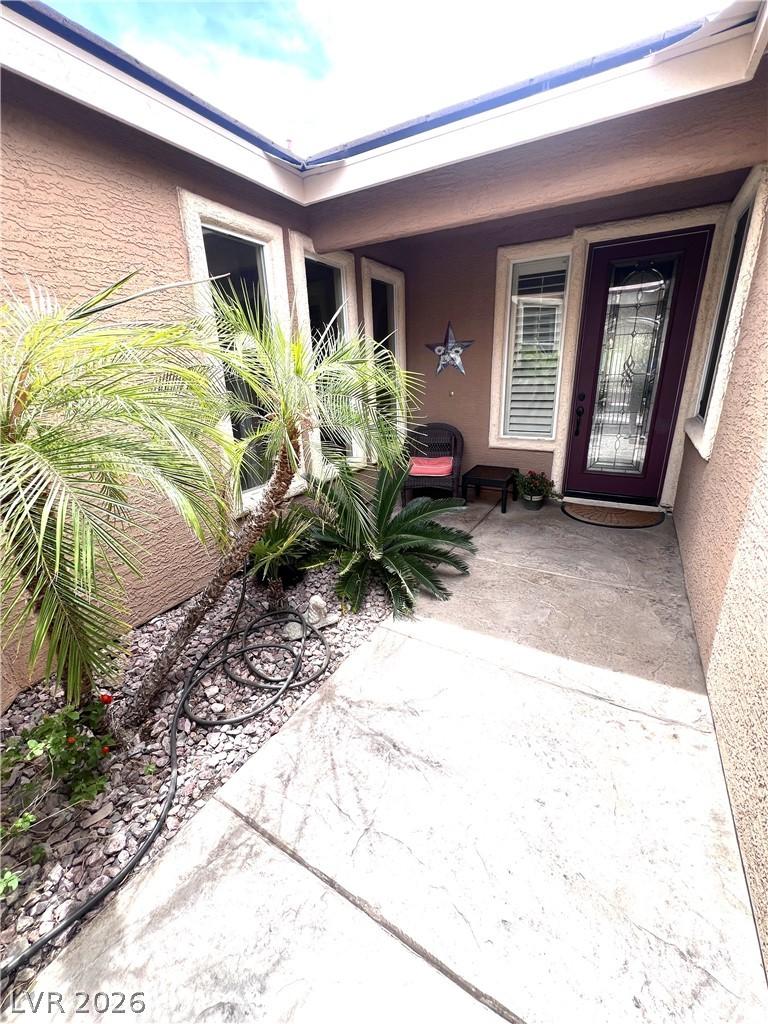 Image 4: A private courtyard entry welcomes you with lush p