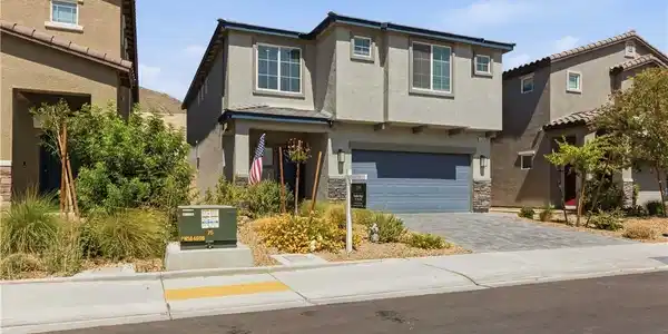 Image 2: A contemporary facade showcases an attached garage