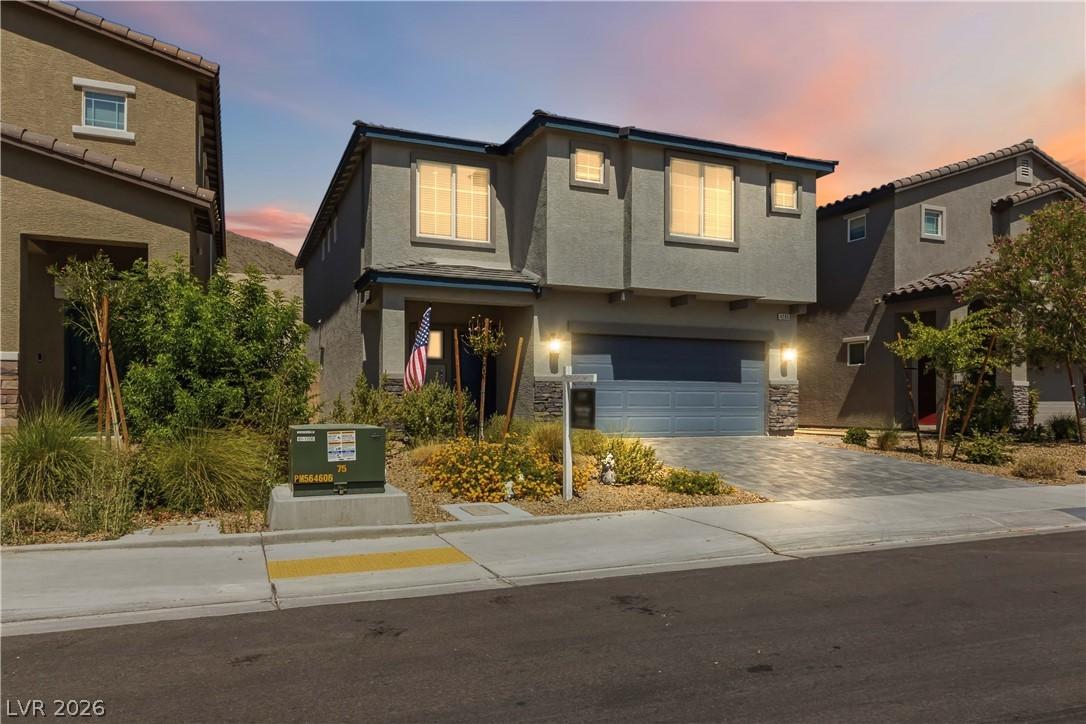 Image 3: A contemporary residence with a paver driveway, of