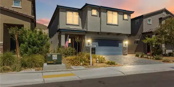 Image 3: A contemporary residence with a paver driveway, of
