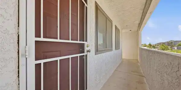 Image 3: An inviting covered walkway entry provides a shade