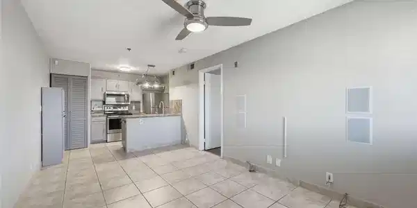 Image 4: Tiled flooring stretches through the open living s