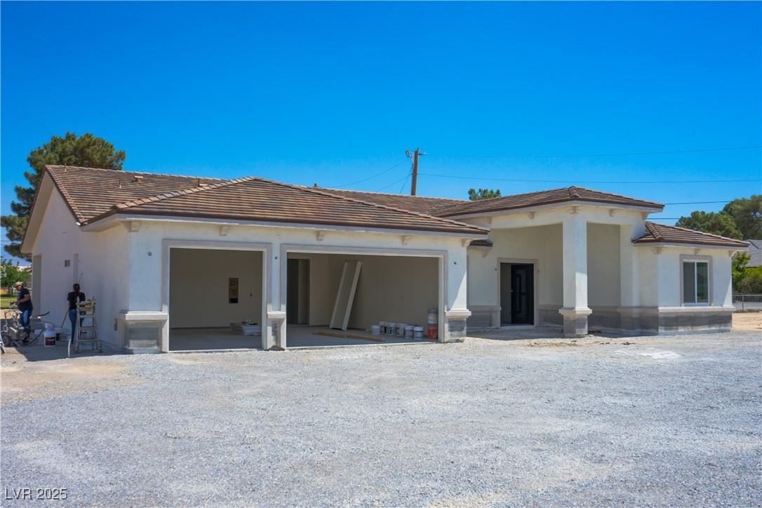 Image 1: View of front of property featuring an attached ga