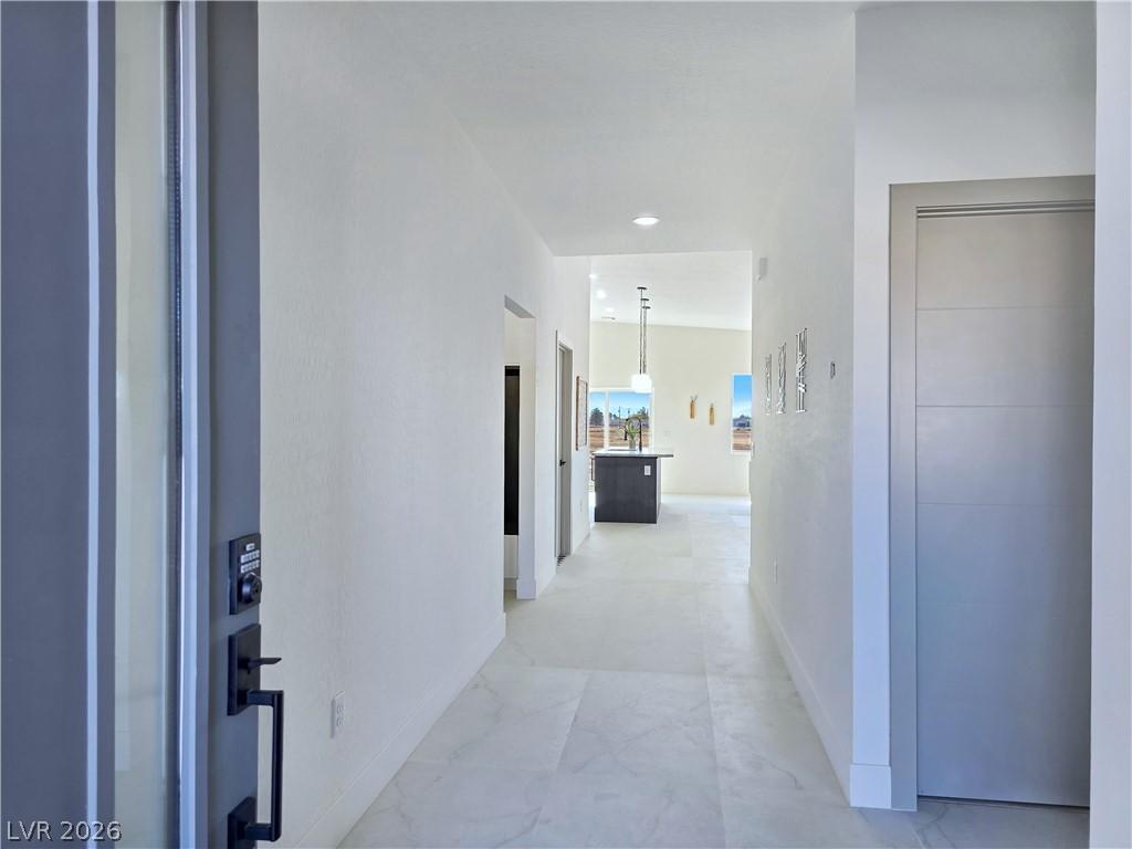 Image 4: Hall with light marble finish floors and recessed