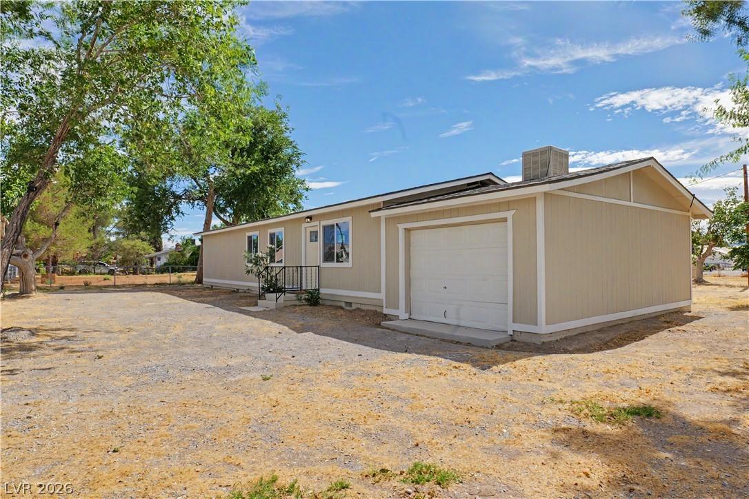 Image 3: A modest single-story home with an attached garage