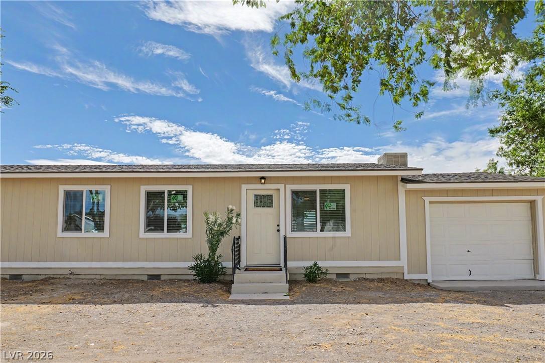 Image 4: A modest home with an attached garage offers invit