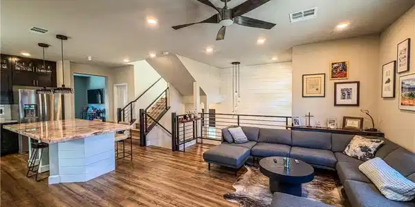 Image 3: Rich wood floors and recessed lighting anchor this