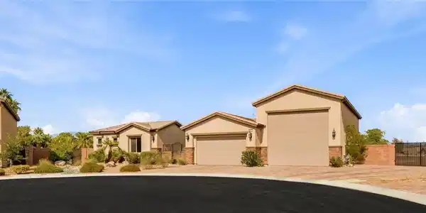 Image 2: Stucco exteriors and multiple garages define this