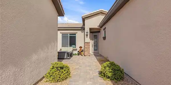Image 3: An inviting stone paver path leads directly to the