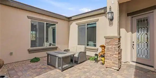 Image 4: An inviting stone paver courtyard leads directly t