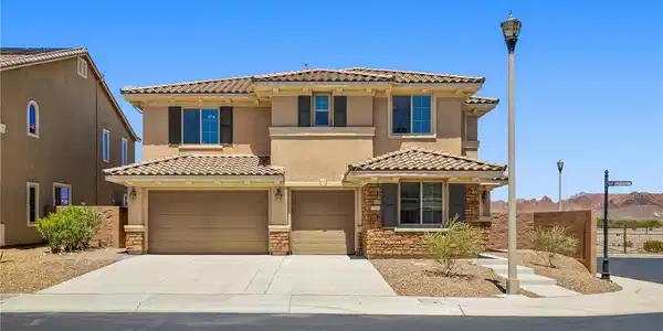 Image 2: A classic two-story residence with a tiled roof an
