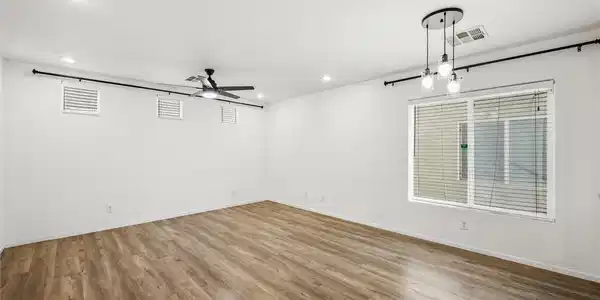 Image 3: Rich wood-inspired flooring pairs with crisp white