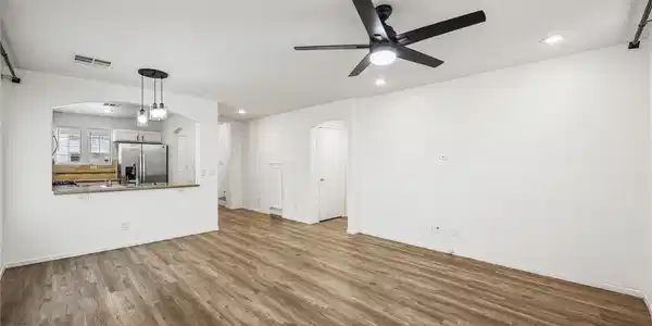 Image 4: Warm wood flooring grounds this airy, open interio