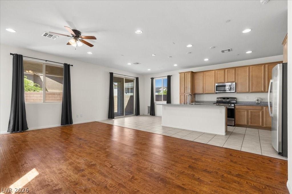Image 3: Open-Concept Living, Kitchen, and Dining Area