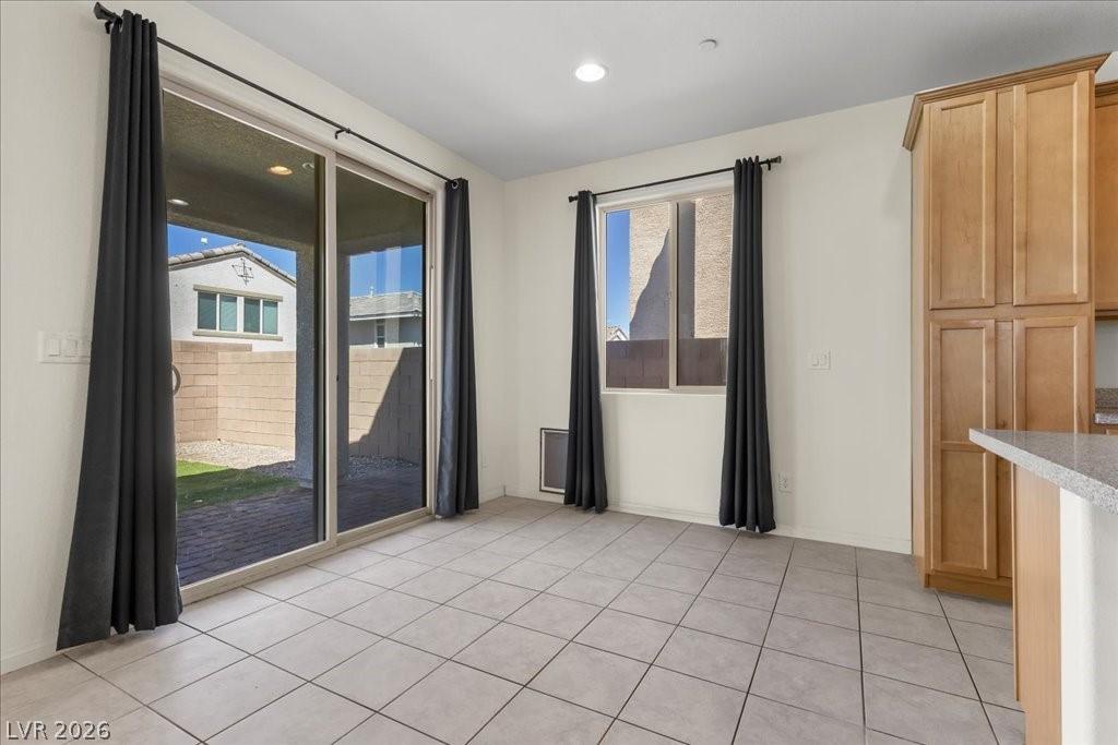 Image 4: Unfurnished dining area with light tile patterned