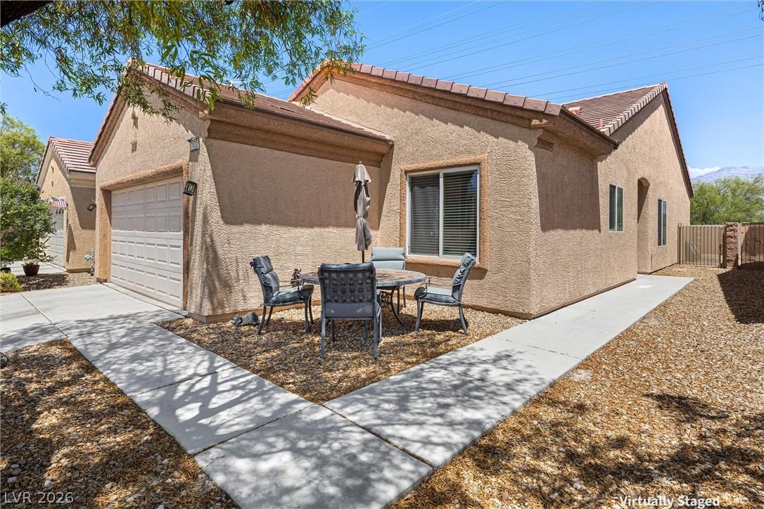 Image 4: A well-maintained stucco home with an attached gar