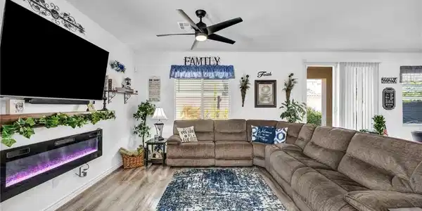 Image 2: Living area with light wood-style flooring, ceilin