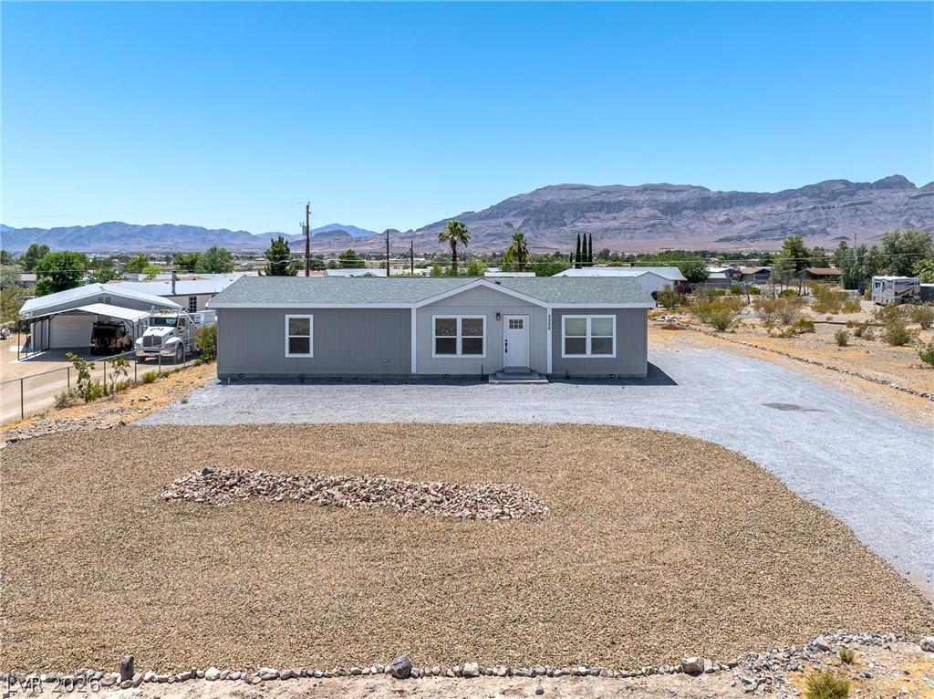 Image 1: A well-maintained single-story residence with a gr