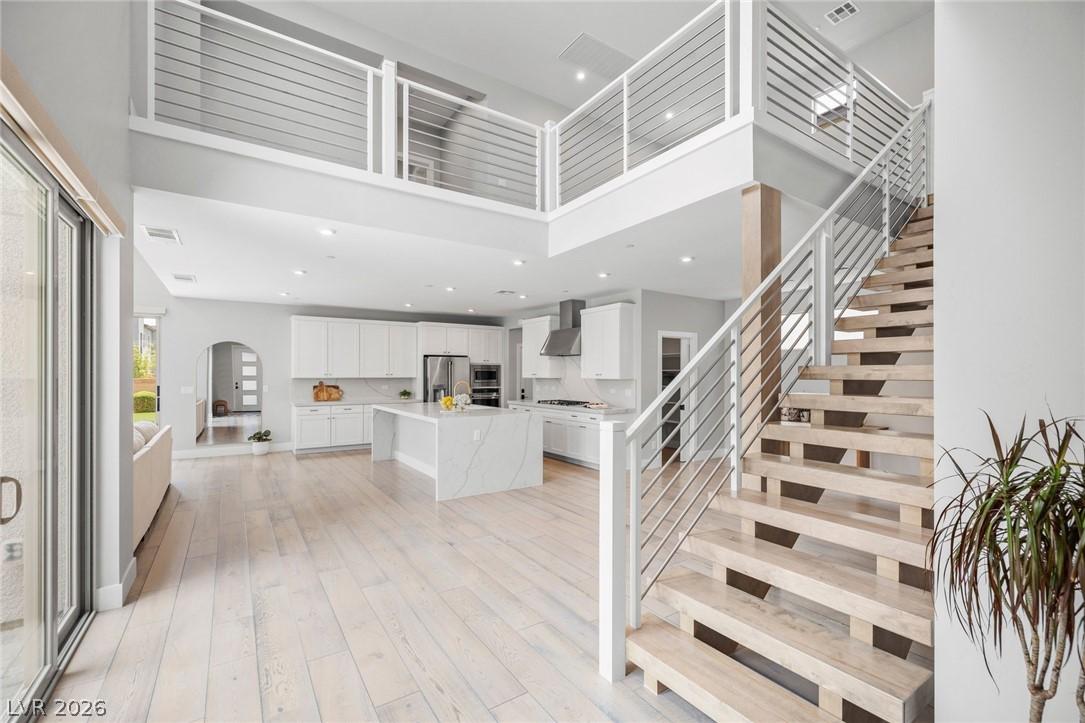 Image 2: An open-concept living space connects a gourmet ki