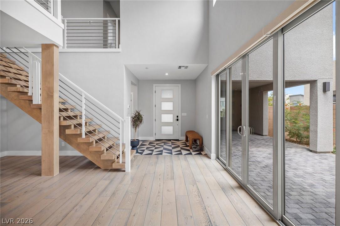 Image 3: A grand entrance with an open staircase and wide p