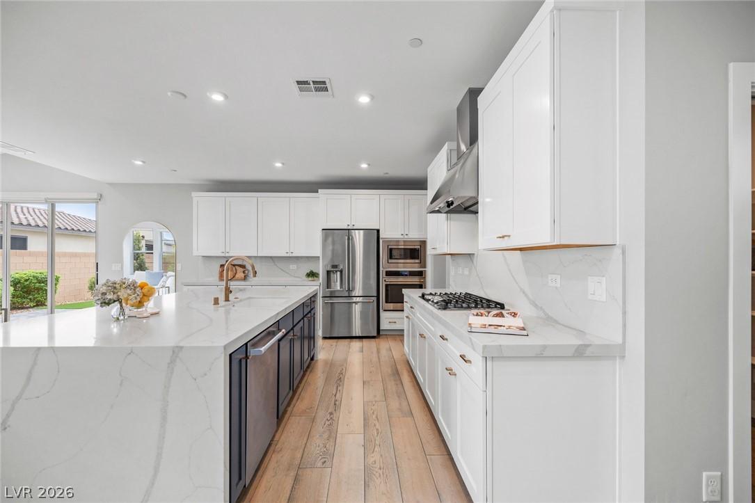 Image 4: A well-lit culinary space showcases an expansive k